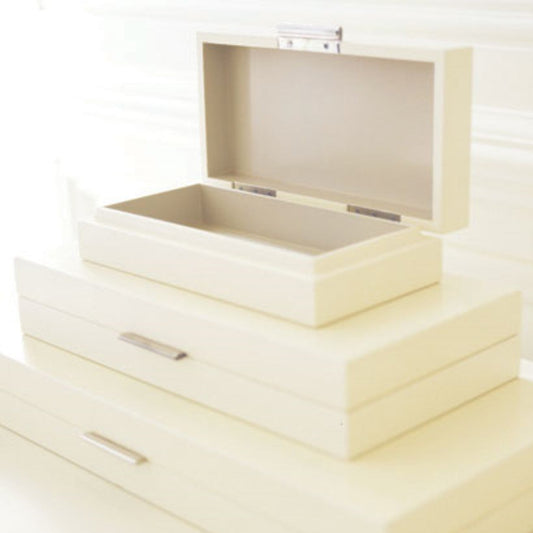 Set of cream-colored jewelry boxes with a metallic clasp on a white background